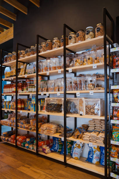 Various food packages and jars on display in rack Various food packages and jars on display in rack. Interior of modern convenience store. Merchandise is in delicatessen. convenience store stock pictures, royalty-free photos & images