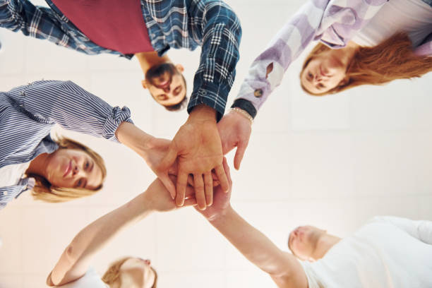 istock Holding each other's hands. Group of friends standing together 1371079408