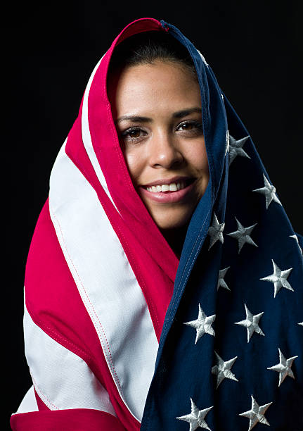 istock hispanic young woman covered with the US flag 137108012