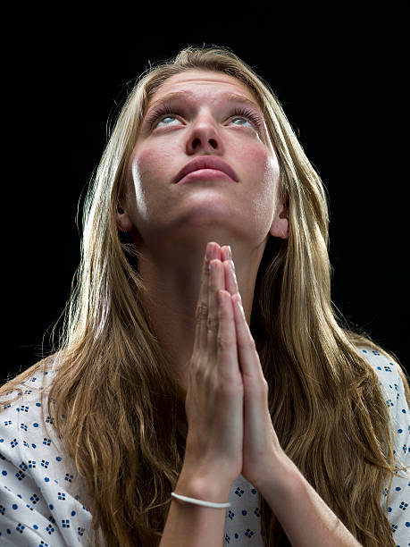 istock blonde young woman praying 137108014