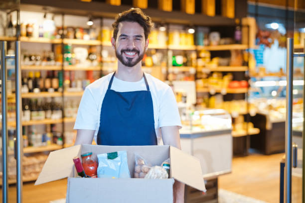 istock Smiling employee holding box with merchandise 1371080416