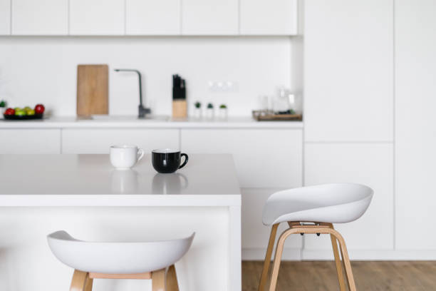 istock White tones kitchen interior design with stylish bar chairs 1371082106