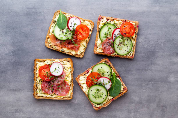 istock Sandwiches with cream cheese, vegetables and salami. 1371083308