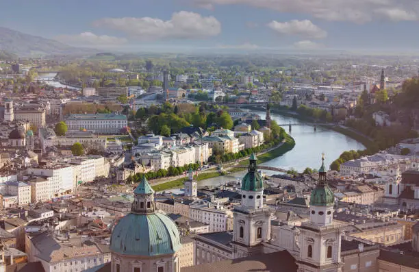 Panoramic view in a Spring season  scene at a historic city of Salzburg with Salzach river in beautiful golden evening light sky at sunset, Salzburger Land, Austria