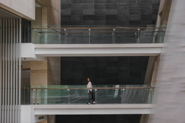 istock Asian Woman Walking on a Corridor 1371084354