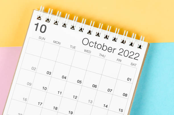 istock October 2022 desk calendar on multicolored background. 1371084472