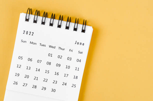 istock June 2022 desk calendar on light yellow background. 1371084473