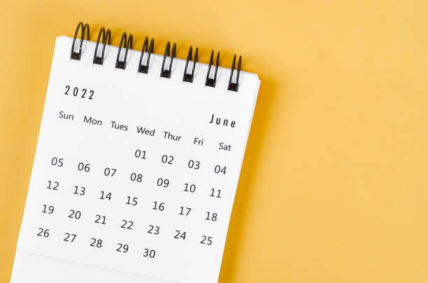 June 2022 desk calendar on light yellow background. The June 2022 desk calendar on light yellow background. june stock pictures, royalty-free photos & images