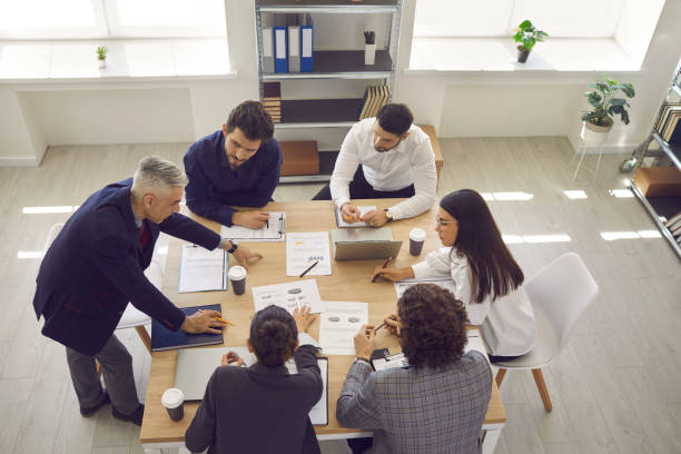 istock Business team analyzes sales charts and diagrams, develops a new strategy and discusses work issues. 1371085400