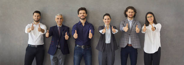 banner with a team of happy successful business people doing a thumbs up gesture - thumbs up business occupation competition imagens e fotografias de stock