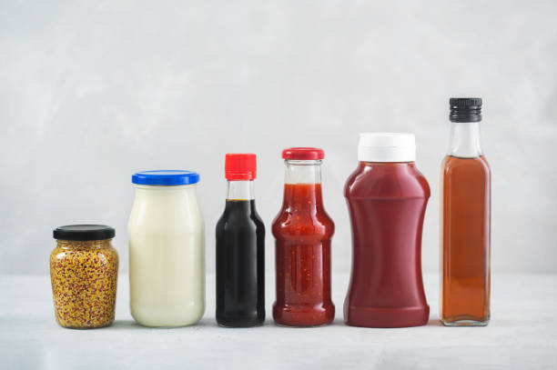 A set of different sauces on the table, gray background A set of different sauces in a bottles on the table, gray background. Ketchup, mayonnaise, barbecue, soy, balsamic and etc food dressing stock pictures, royalty-free photos & images