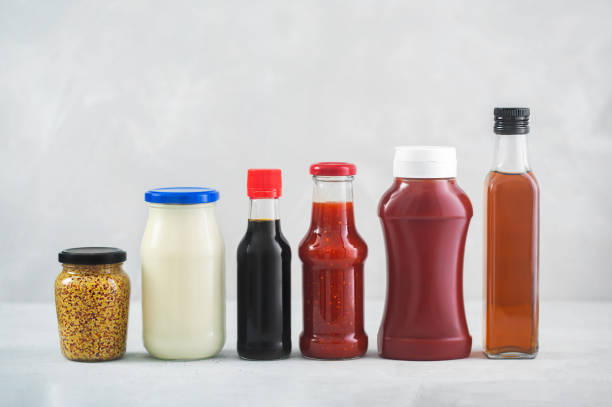 A set of different sauces on the table, gray background A set of different sauces in a bottles on the table, gray background. Ketchup, mayonnaise, barbecue, soy, balsamic and etc condiment stock pictures, royalty-free photos & images