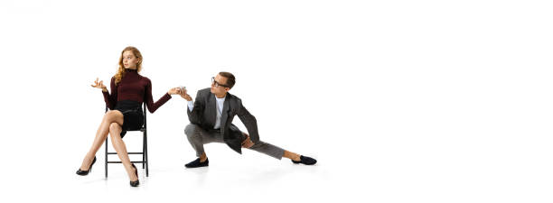 istock Flirt at work space. Two stylish office workers in business suits isolated on white background. Human rights, diversity, relation, fashion and business concept 1371087479