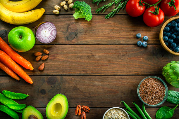 istock Healthy vegan food frame on wood table. Copy space 1371090572