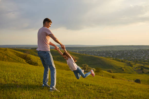 istock Carefree father and daughter having fun on hill 1371092319