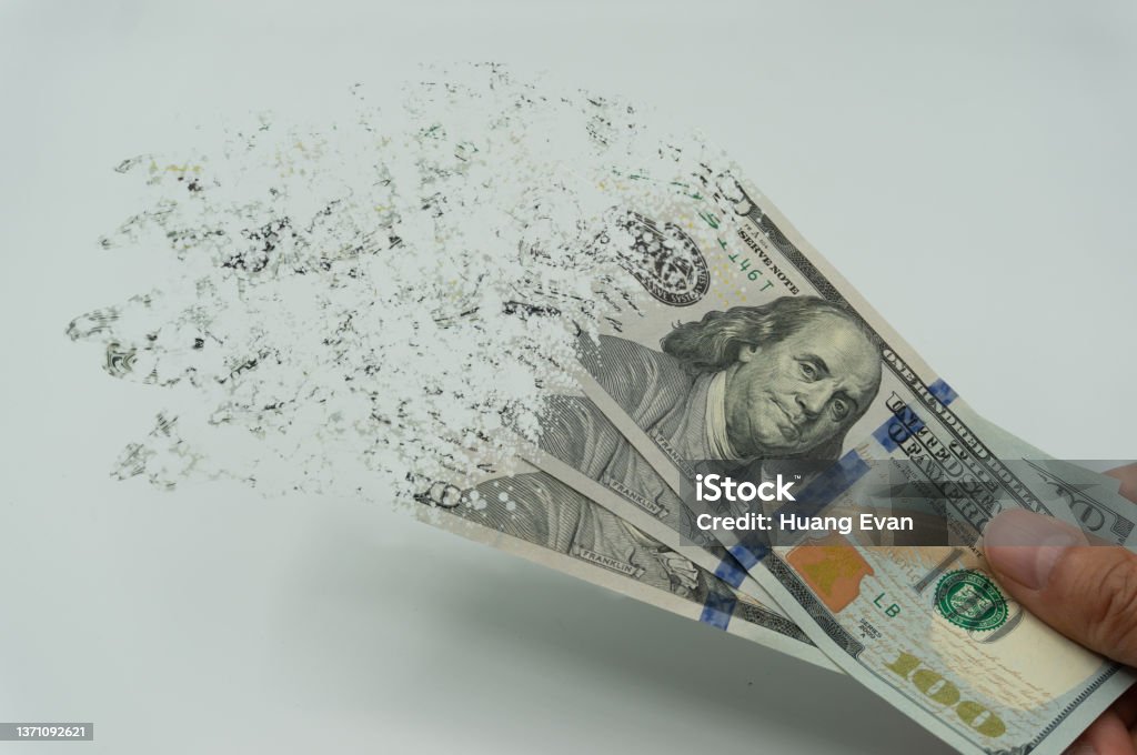 The man's hand holds a 10000 Korean won, which crushes and flutters in the wind. The concept of currency devaluation and economic crisis.collapse, stagnation ·economy.Spending and loans,covid 19. Inflation - Economics Stock Photo
