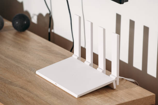 istock White Wi-Fi 6 router with 4 antennas on a loft table. 1371092683