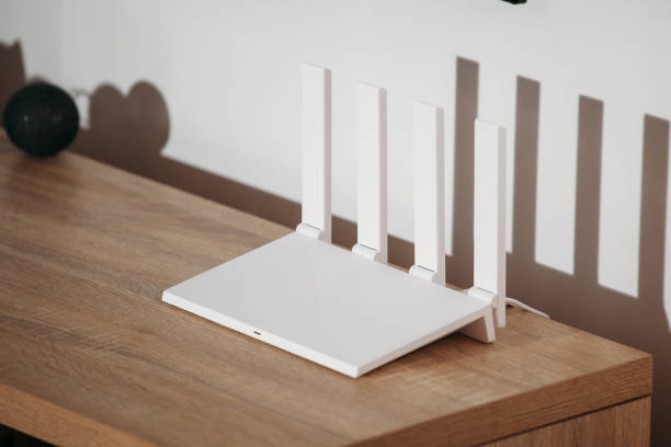 istock White Wi-Fi 6 router with 4 antennas on a loft table. 1371092752