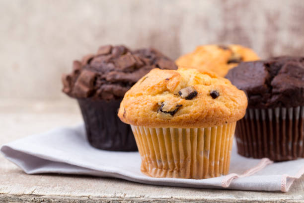 istock Homemade muffins with chocolate, vintage background. 1371094271
