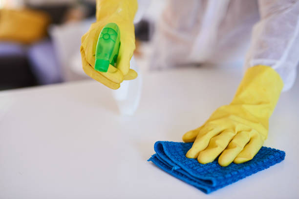 istock A cleaning professional sprays a kitchen counter with sanitiser 1371094895