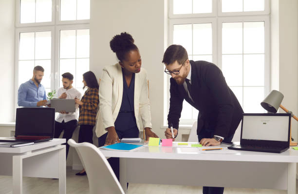 istock African american employee working with caucasian project manager in office 1371094928