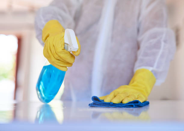 istock A cleaning professional sprays a kitchen counter with sanitiser 1371094940
