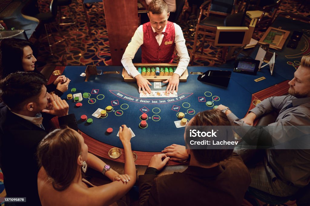 Group of people gambling sitting at a table in a casino top view Group of people gambling sitting at a table in a casino top view. Betting gambling. Casino Stock Photo