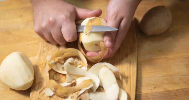 istock peeling a potato on a wooden table 1371097317