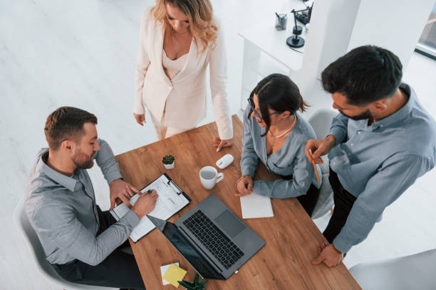 istock Top view of business people that working by using laptop 1371101475