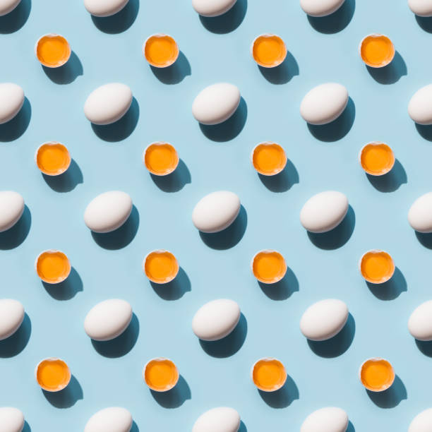 istock Organic white eggs and yolk with shadow on blue background. Seamless pattern. 1371102508