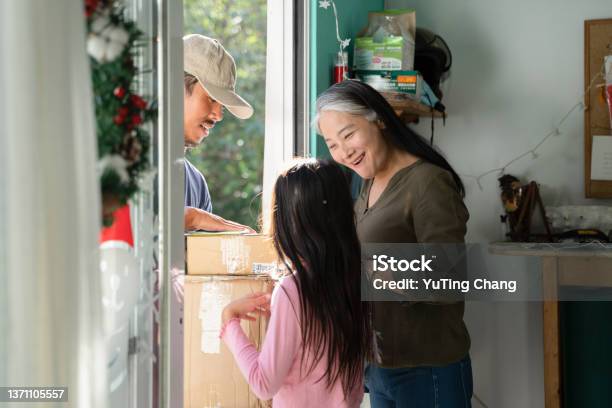 Mother And Daughter Received Courier Packages At Christmas Stock Photo - Download Image Now