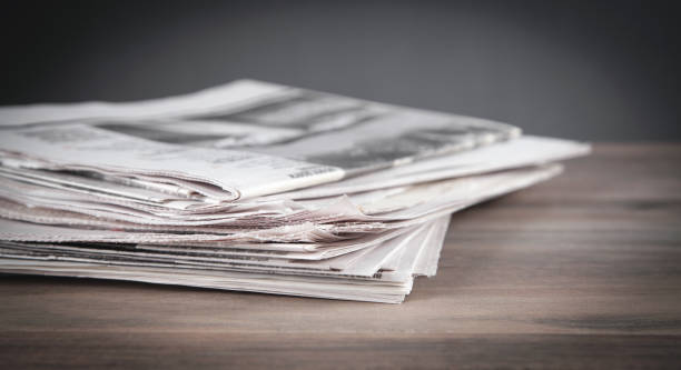 Newspapers on the wooden table. stock photo