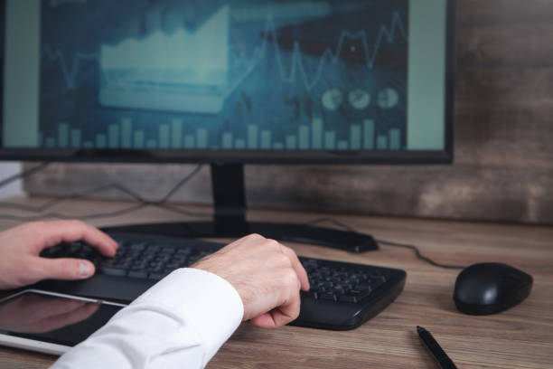 istock Businessman working with analytics sitting at the working place with computer. Graphs and charts on computer screen. Business. Finance. Accounting 1371107996