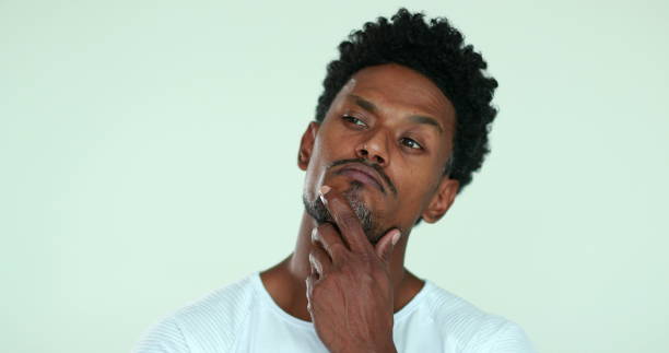 istock Black person thinking with hand in chin. African man deciding 1371109605