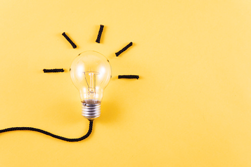 Innovation concept with light bulb and ropes on blue background