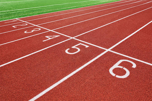 istock Red running track at stadium with lane numbers 1371115830