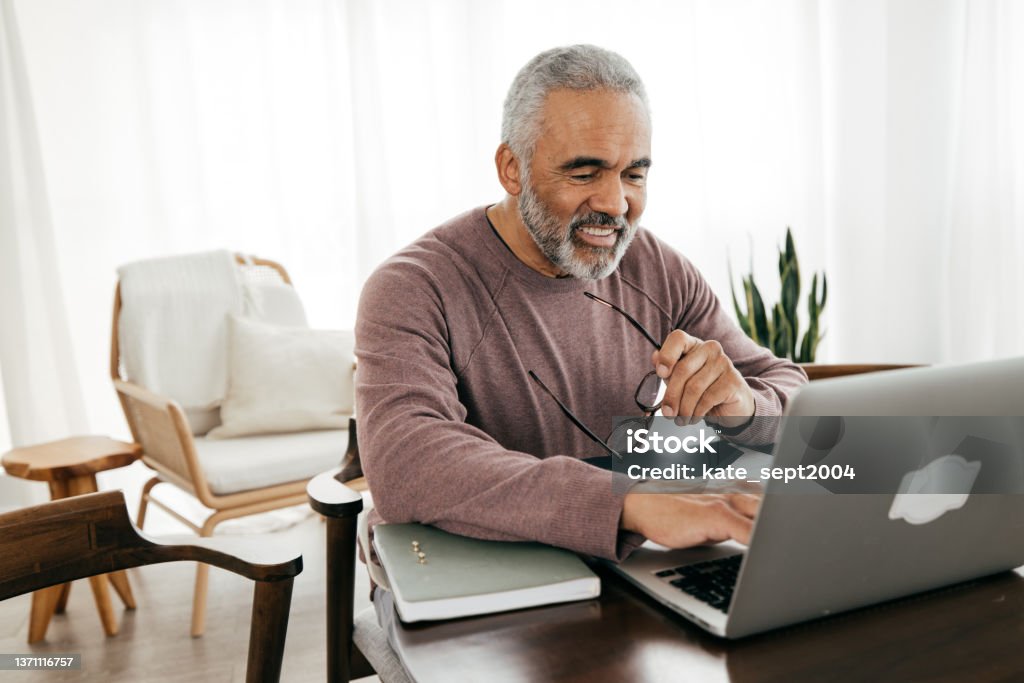 A budgeting  app can be a great tool to help you meet your goals Senior men taking online lesson Senior Adult Stock Photo