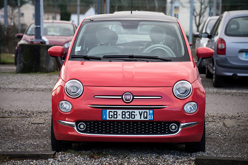 Mulhouse - France - 17 February 2022 - Front view of corail color Fiat 500 parked in the street