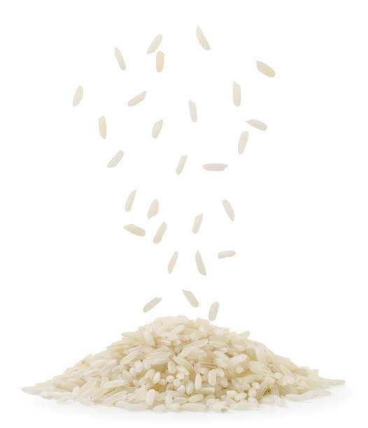 Rice falling on a pile on a white background. Isolated