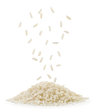 Rice falling on a pile close-up on a white background. Isolated