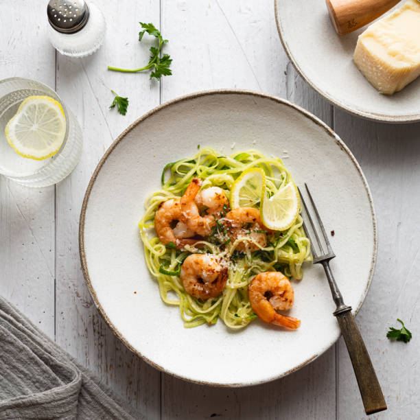 istock Zucchini pasta with shrimps on concrete background 1371121318