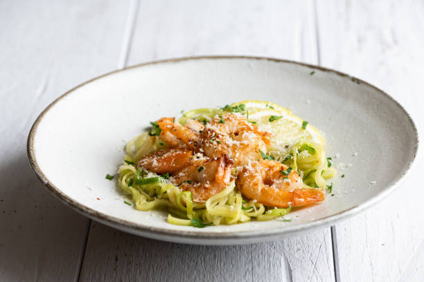 istock Zucchini pasta with shrimps on concrete background 1371121319