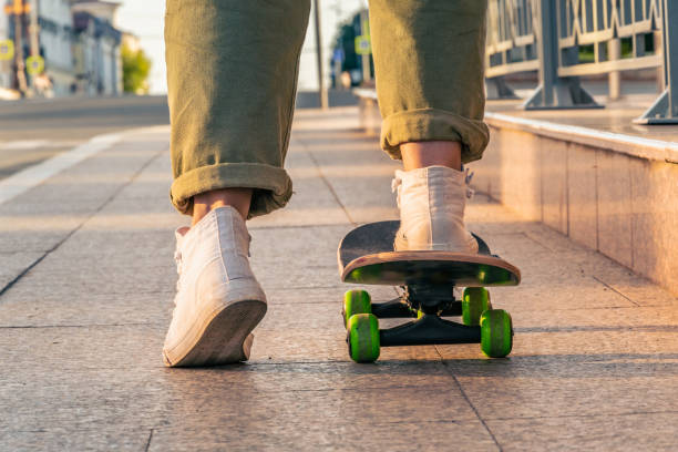 istock Close-up of a woman's legs on a skateboard 1371124767
