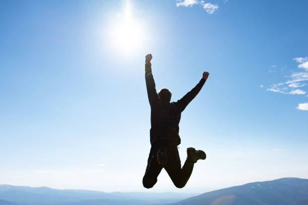 istock Sport man jumping and celebrating with arms raised 1371126466
