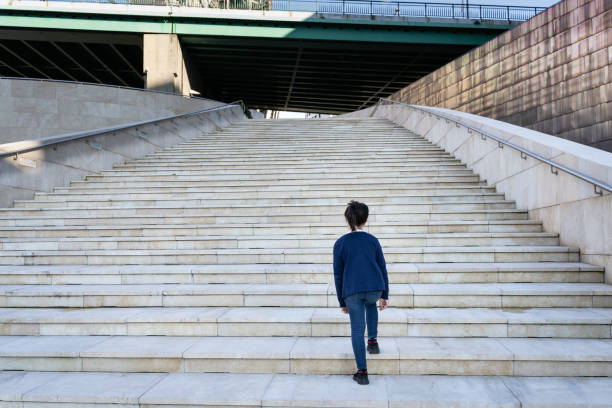 istock Little girl walking alone upstairs 1371127268