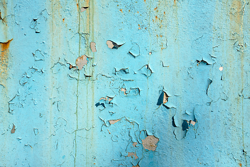 Blue colored old metal background with peeling paint and rusty spots. Corrosion and rust concept.