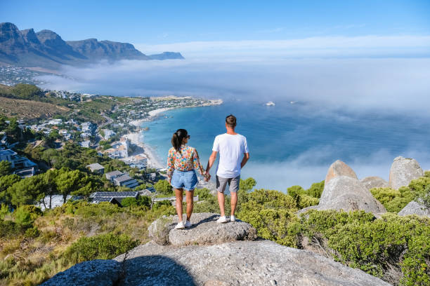 view from the rock viewpoint in cape town over campsbay, view over camps bay with fog over the ocean - zuid afrika stockfoto's en -beelden