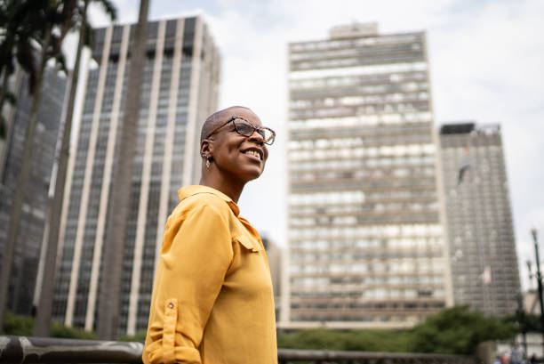 Contemplative mature woman looking away in the city