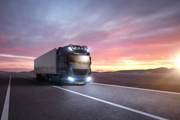 istock Truck driving on a highway at sunset 1371130605