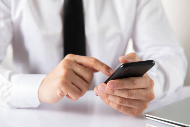 istock Businessman is Typing on Mobile Phone 1371131083